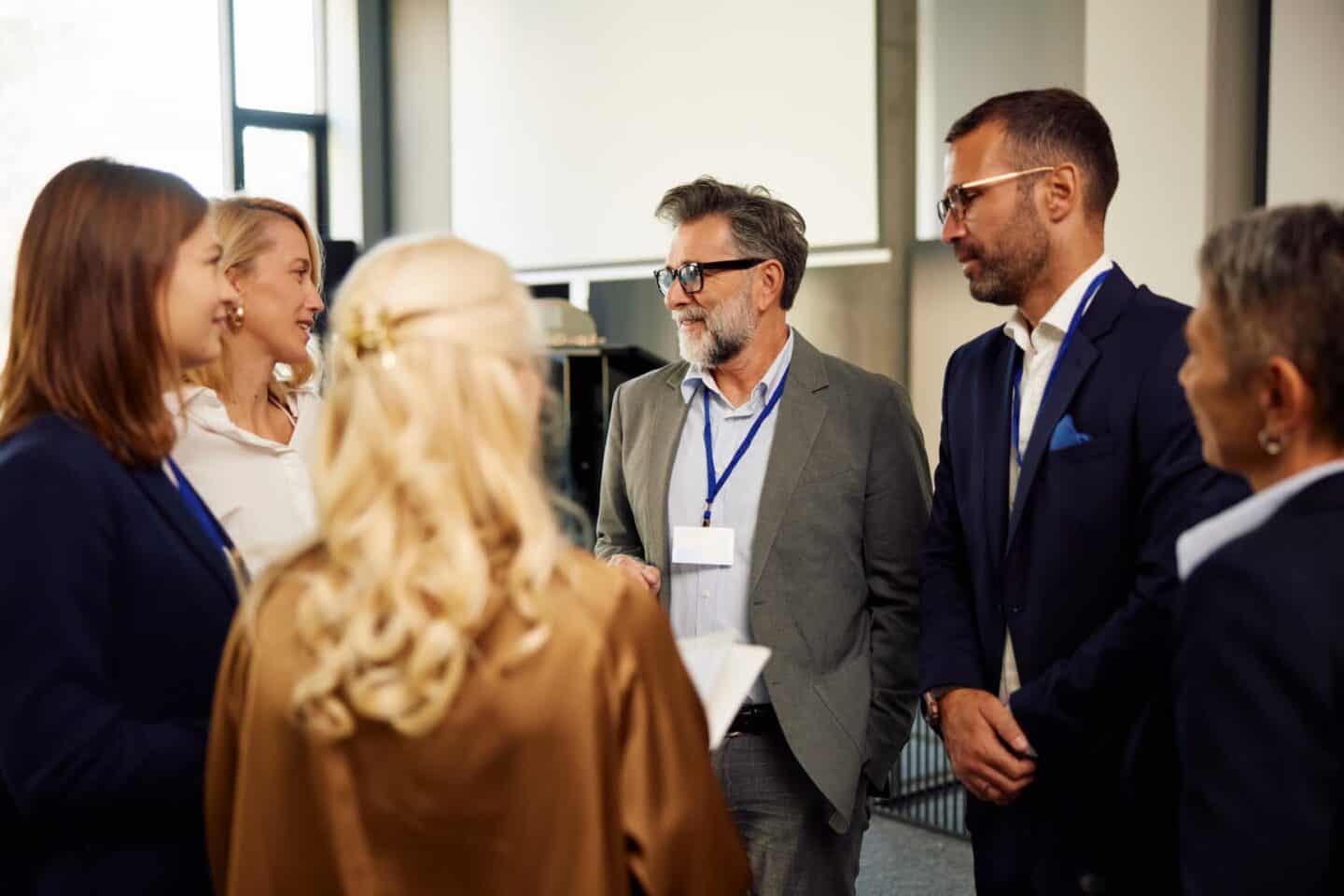 Group of colleagues discussing business-related topics during leadership development
