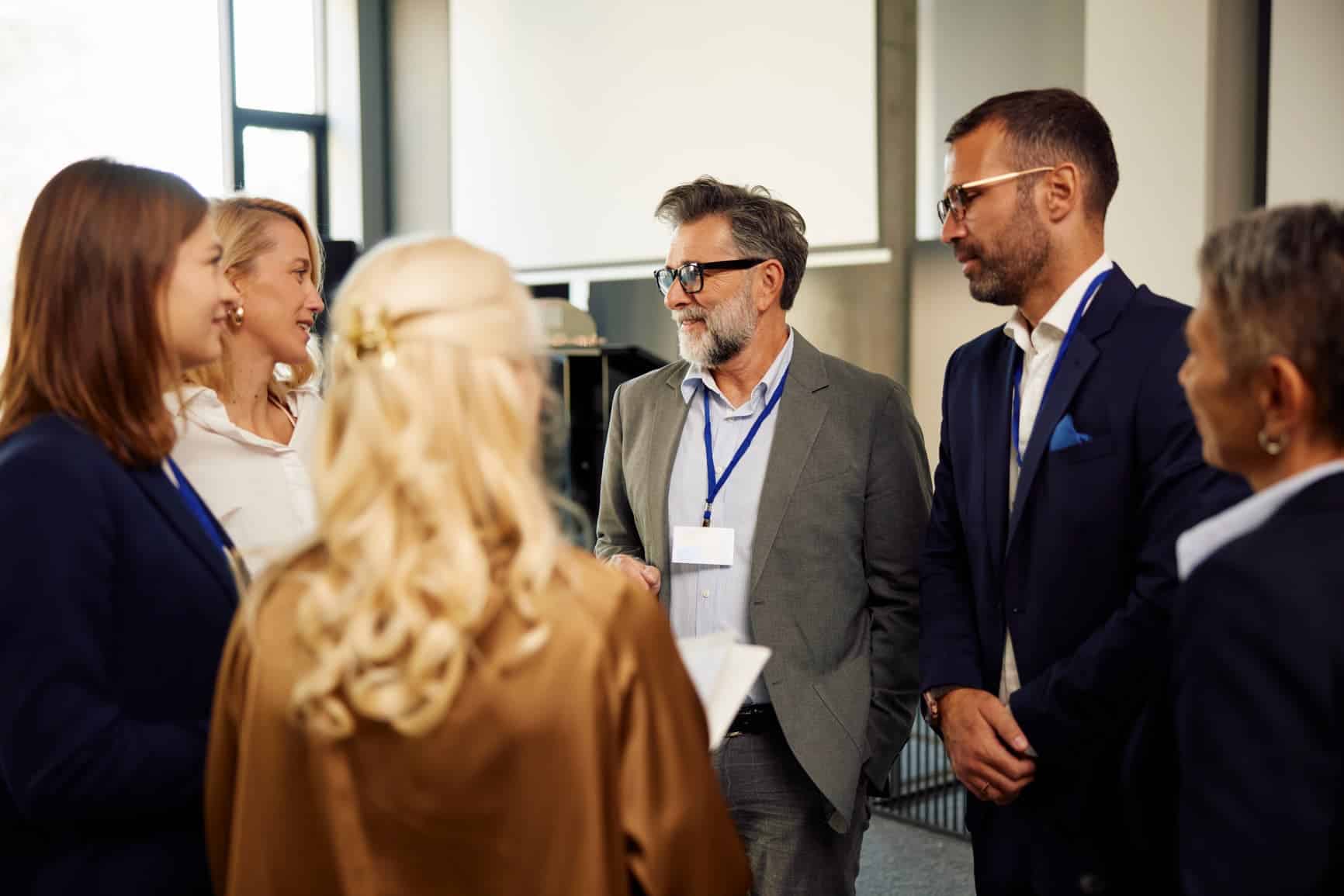 Group of colleagues discussing business-related topics during leadership development