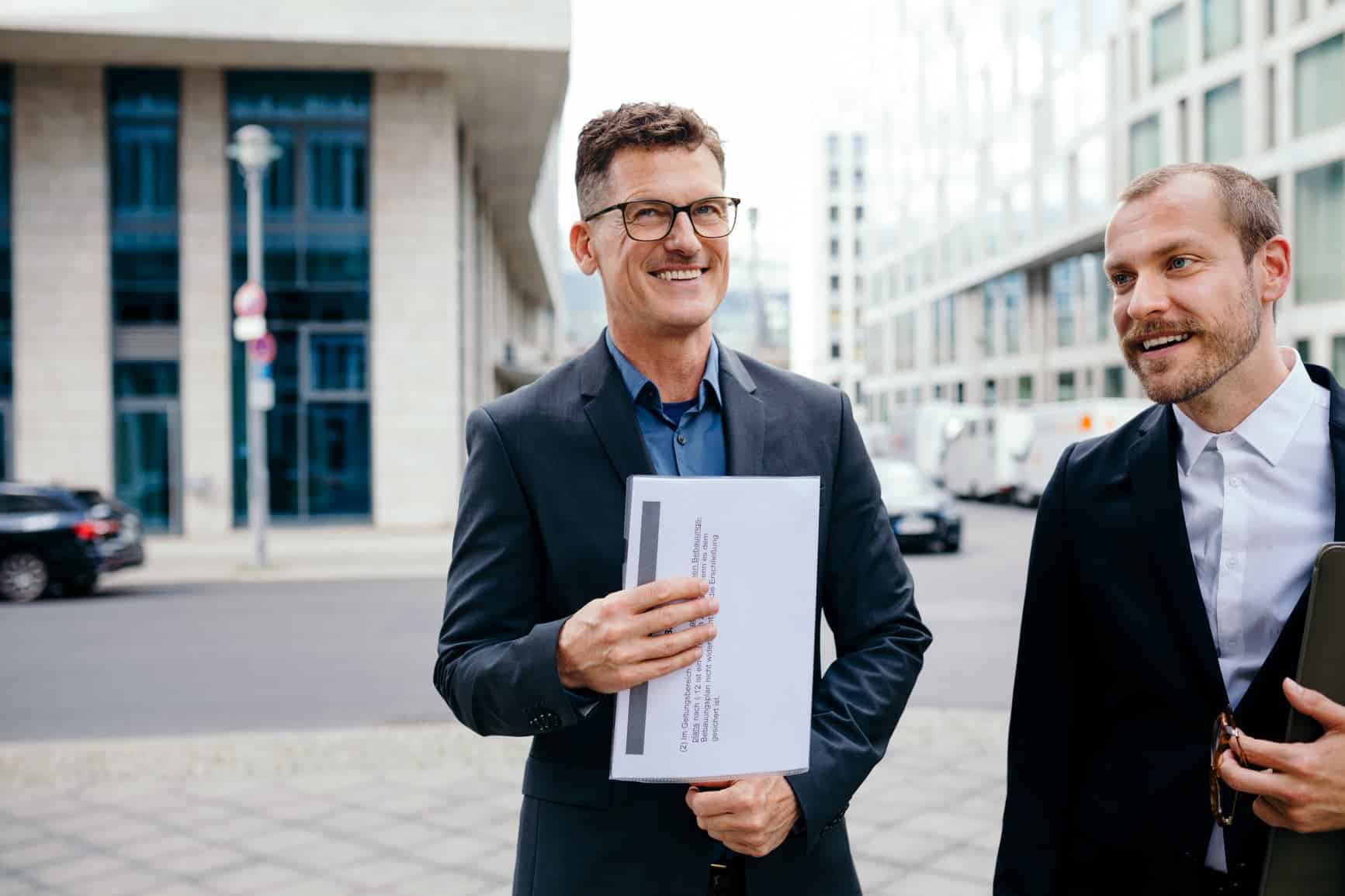 Professional colleagues in suits looking happy and are representing strong leadership